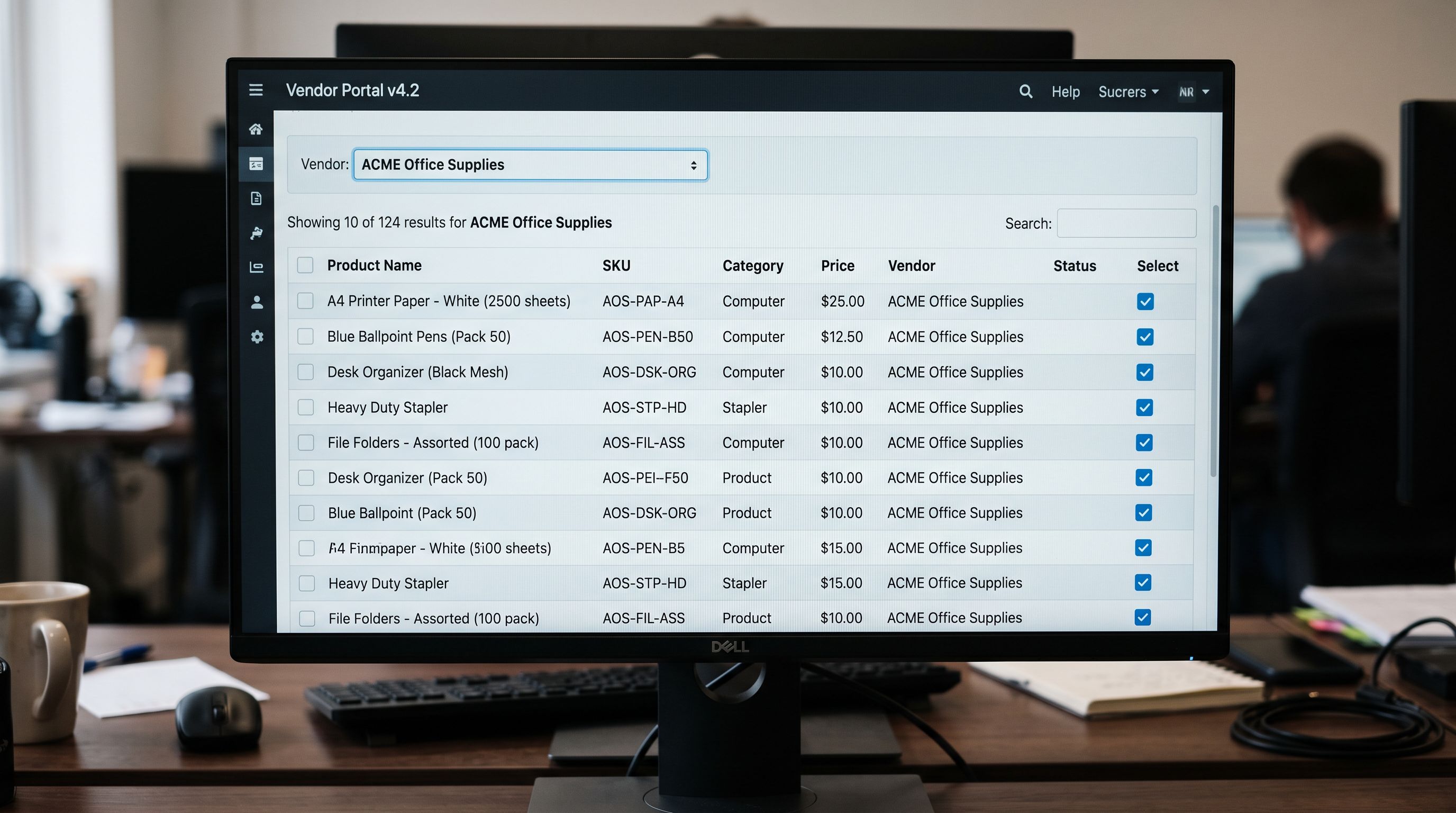 A monitor screen showing a product list filtered by vendor name with all results belonging to a single Collective supplier-partner, checkboxes selected across the list, sharp focus on the screen, colour photography.