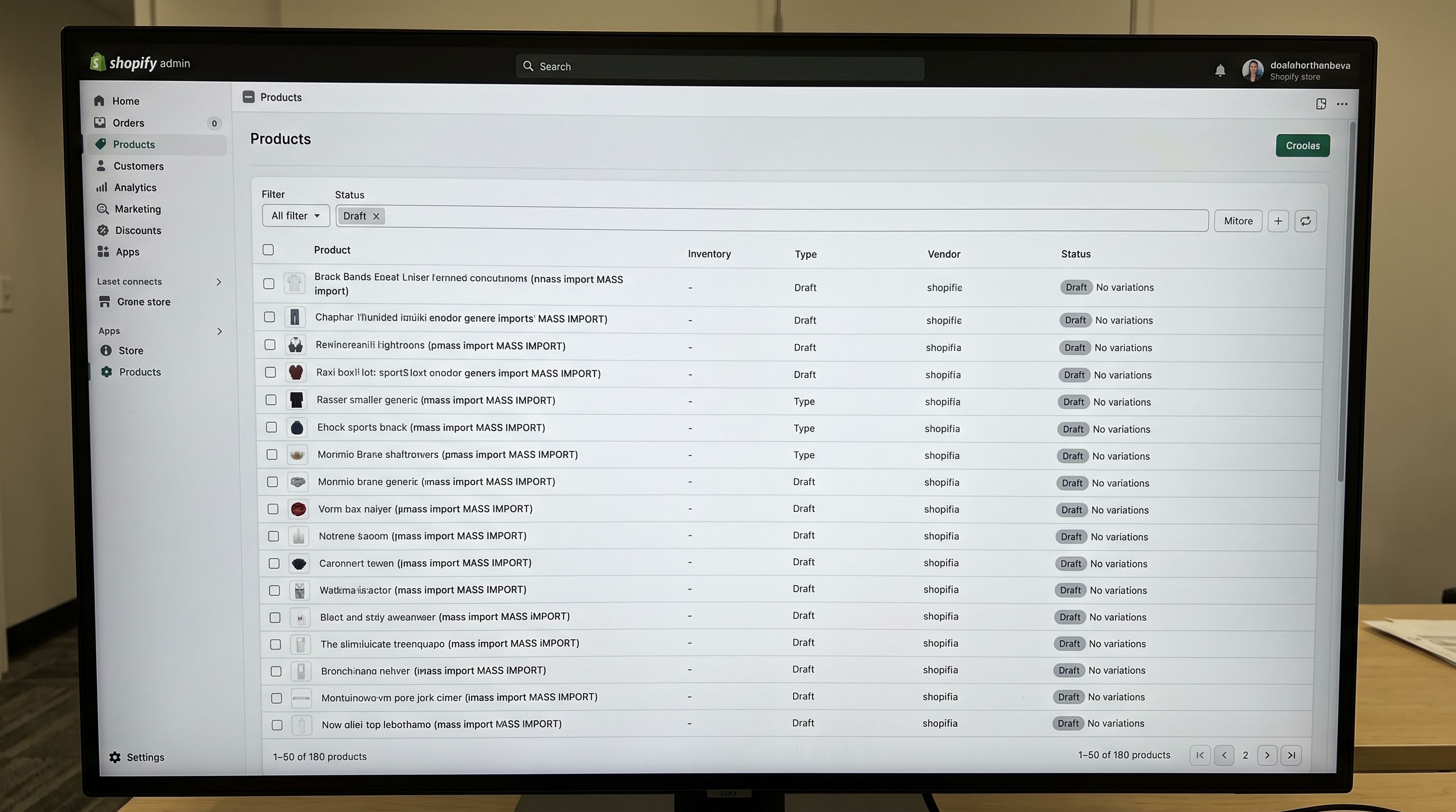 A Shopify admin products list on a monitor showing 180 products in Draft status after a new store import, with the filter bar showing Draft selected and the status column uniformly showing Draft across all visible products, representing the complete first-pass import of a new store catalogue before any products are made active, everything in sharp focus no blur no depth of field, colour photography.