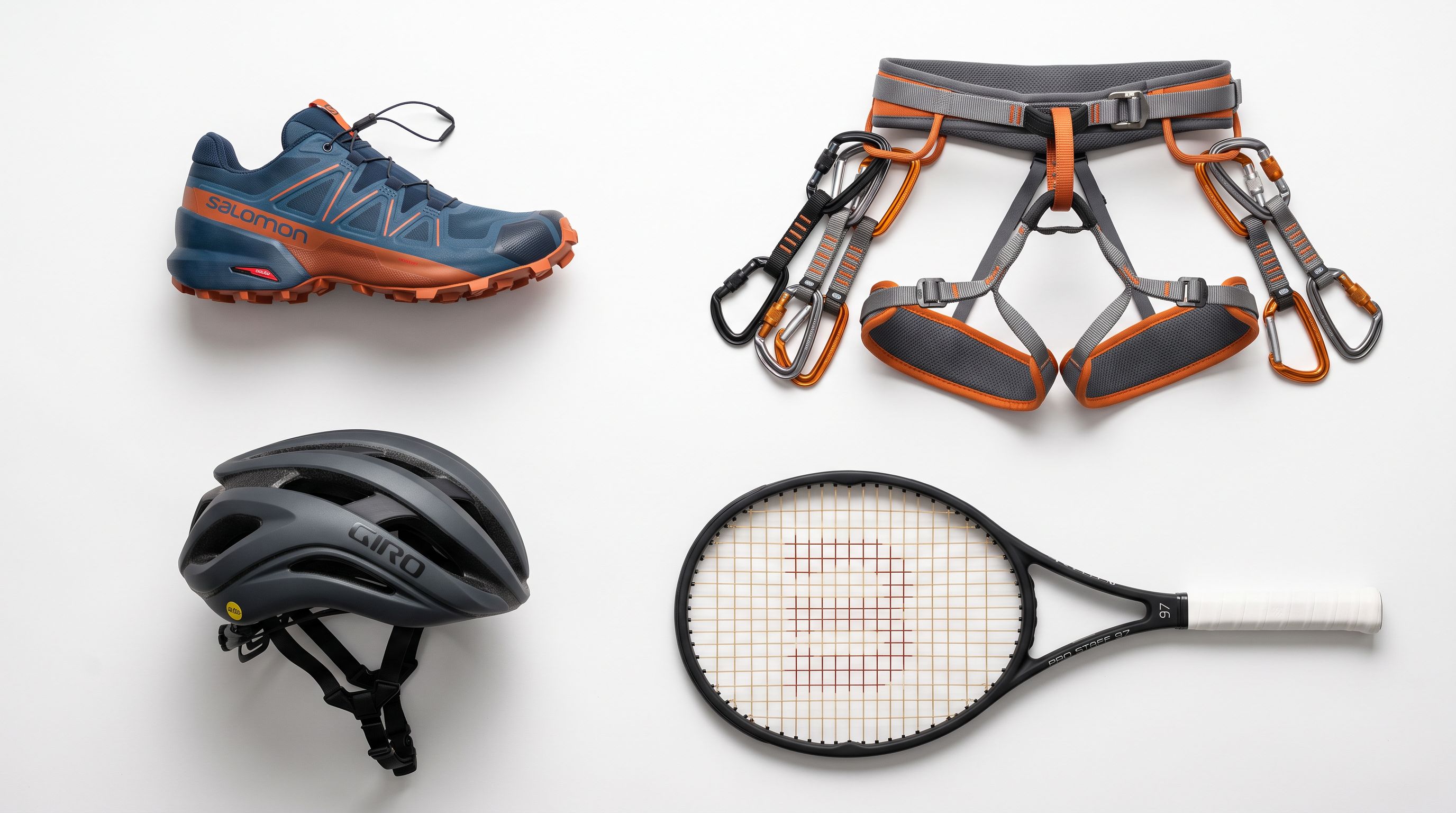 A flat lay of sporting goods on a white surface: a trail running shoe, climbing harness with carabiners, cycling helmet, and tennis racket arranged evenly and photographed from above.