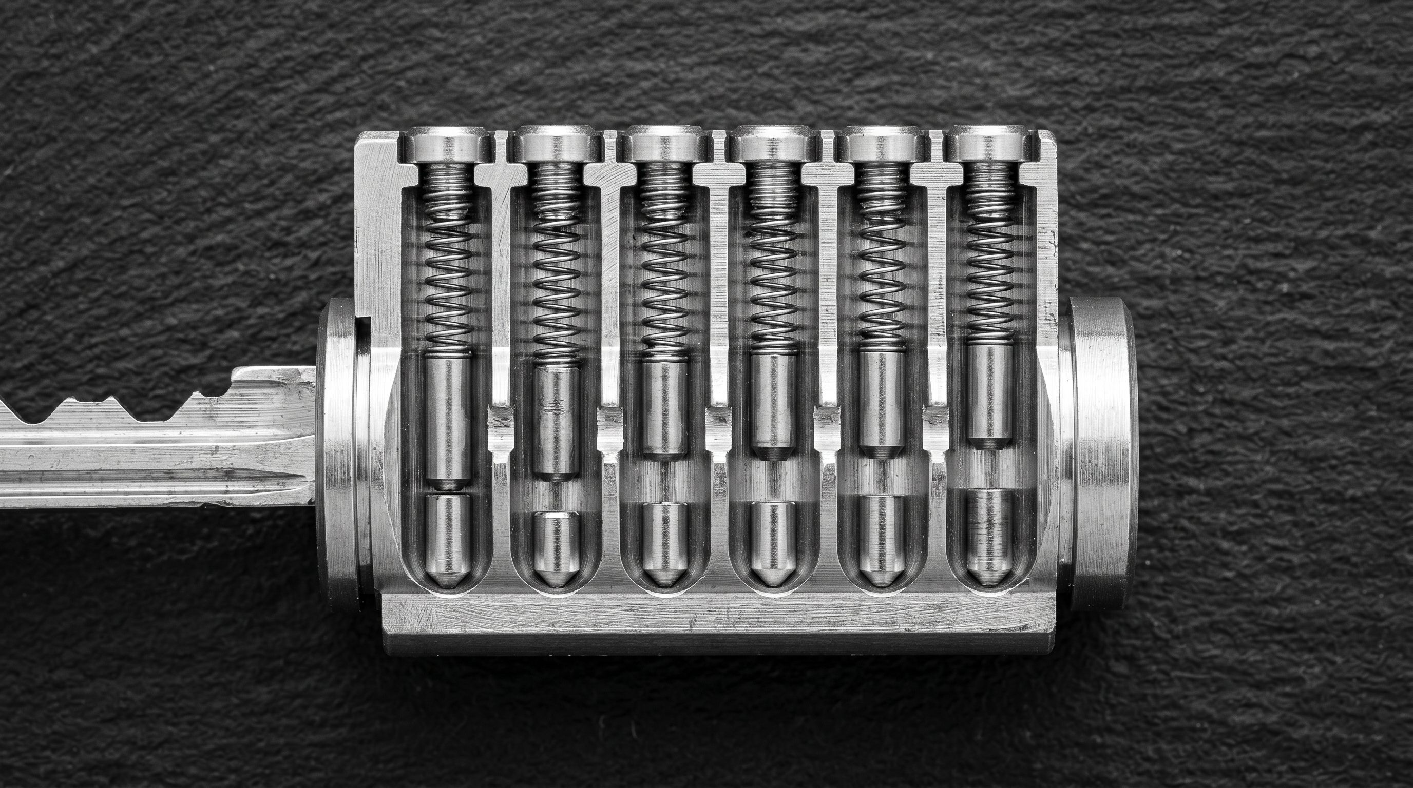Precision lock cylinder cross-section showing internal pin alignment at different heights.